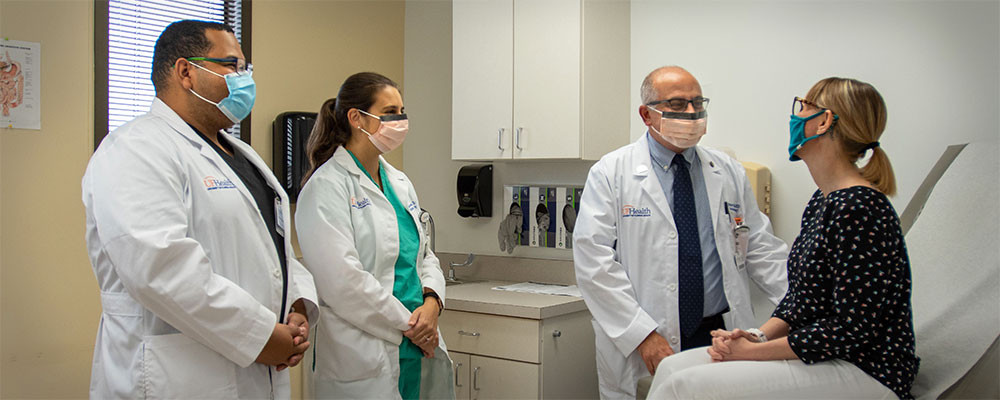 University of Florida gastroenterologists meet with a patient at UF Health Jacksonville.