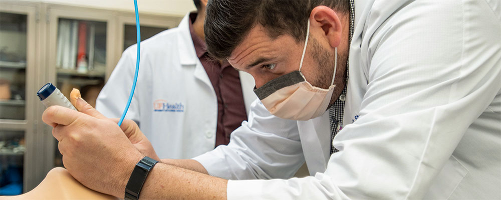 University of Florida pulmonary and critical care medicine fellow practices intubation.
